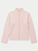 A light pink knit mock-neck sweater with a central braided cord detail running down the front, displayed on a clean, light gray background.